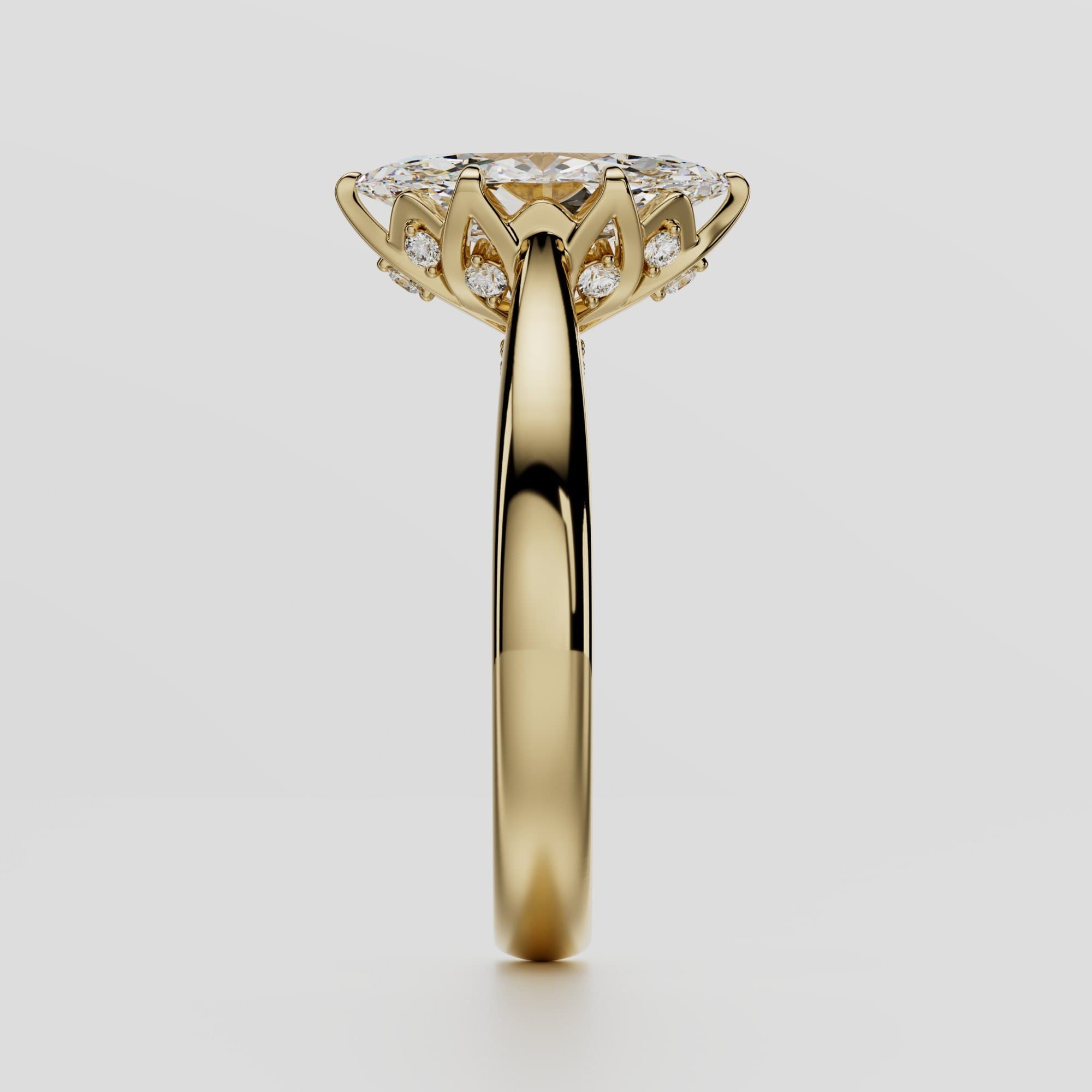 Side profile of a marquise-cut diamond engagement ring showing the ornate diamond-set gallery and tapered yellow-gold band