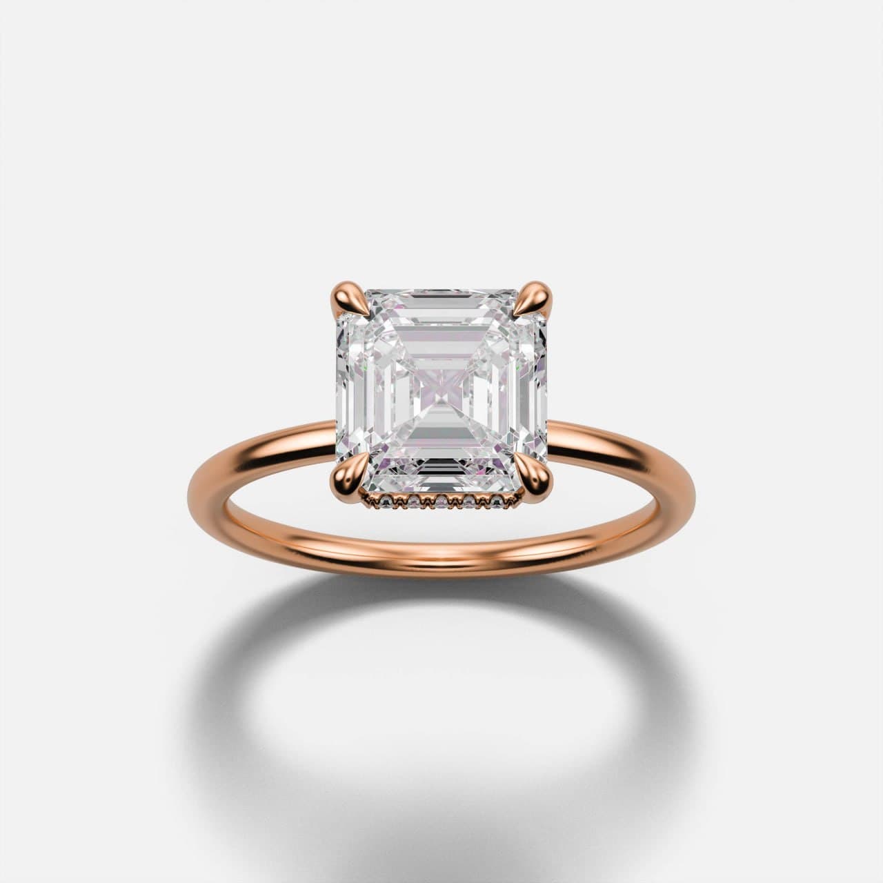 Rose gold Asscher-cut diamond solitaire engagement ring viewed head-on, square step-cut stone in single tapered claws on a knife-thin band