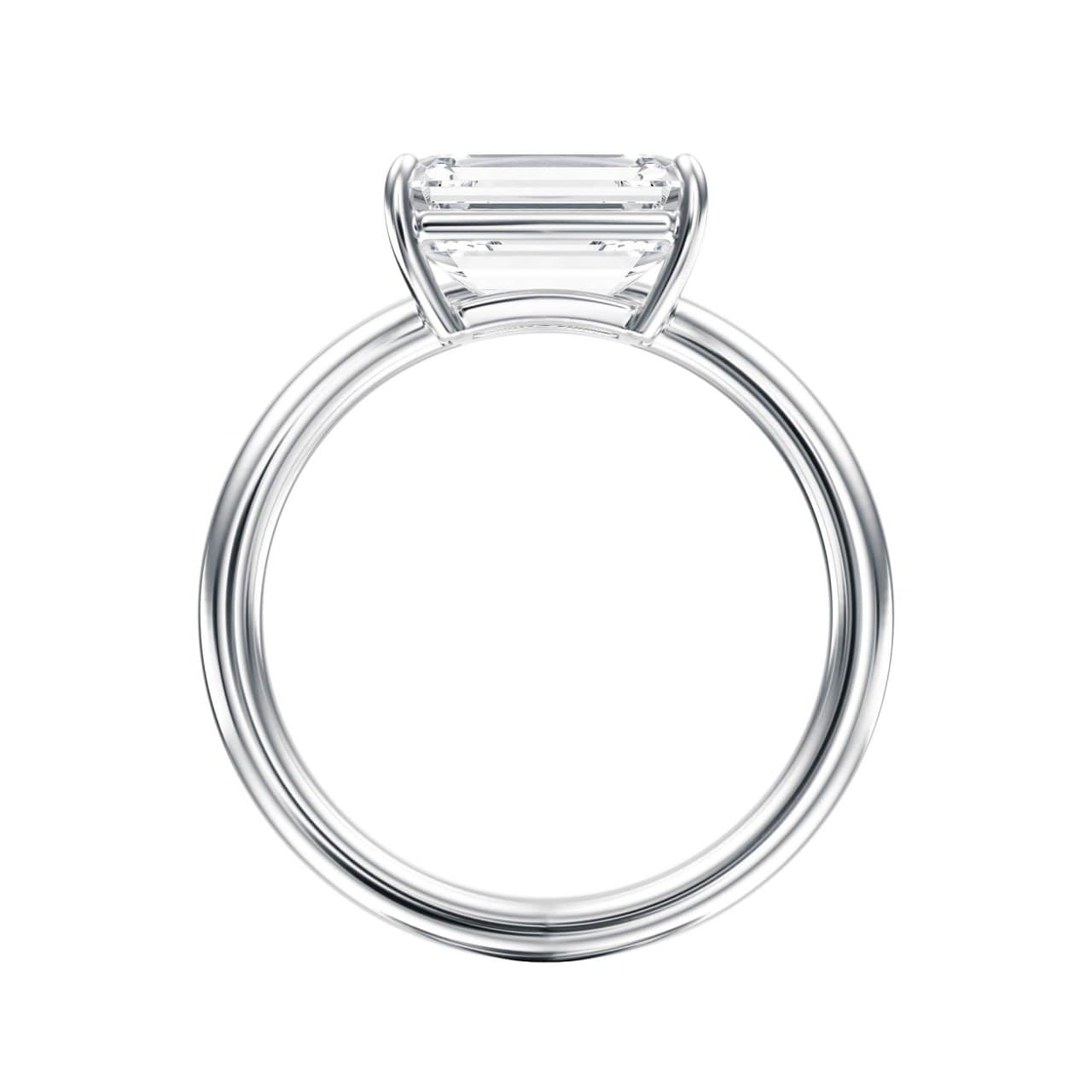 East-west emerald-cut solitaire engagement ring in white gold, front view — minimalist contoured band, photorealistic 3D render by 4rend Studio