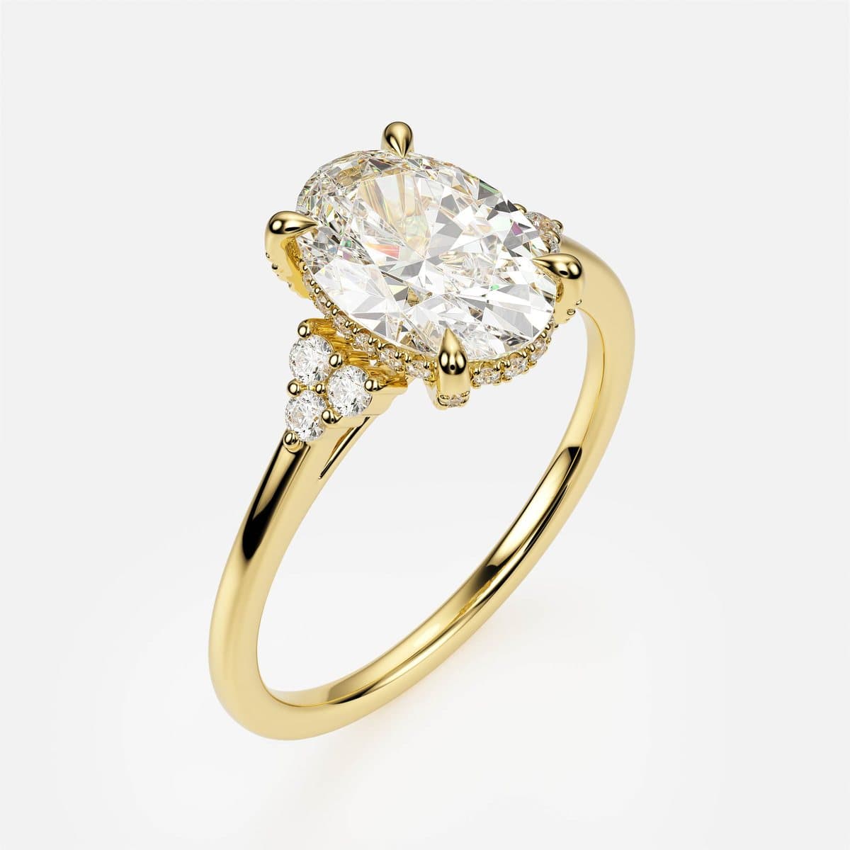 nanea Trio Bloom engagement ring in yellow gold — a solitaire with side-stone trios and a hidden halo
