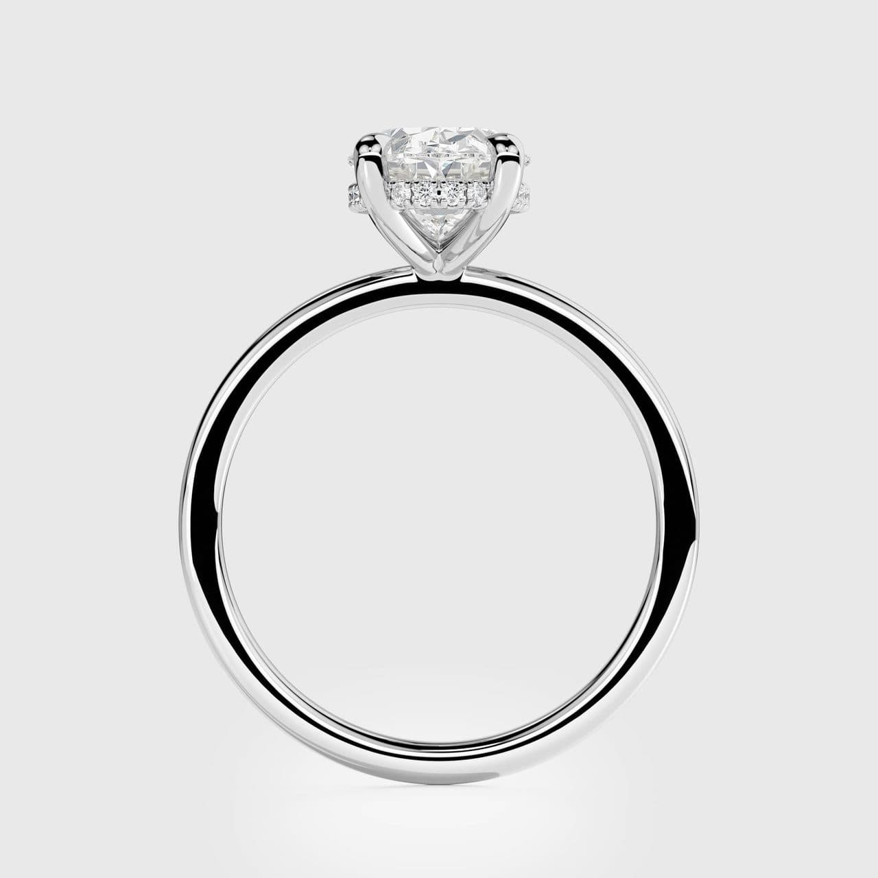 White gold oval solitaire standing upright, seen straight through the shank, polished band showing sharp light and dark reflection bands