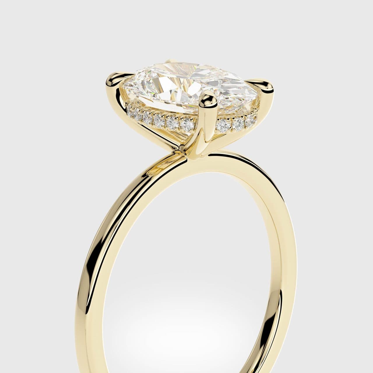 Close three-quarter view of a yellow gold oval diamond solitaire with a hidden halo under the centre stone and four claws — photorealistic 3D render by 4rend Studio